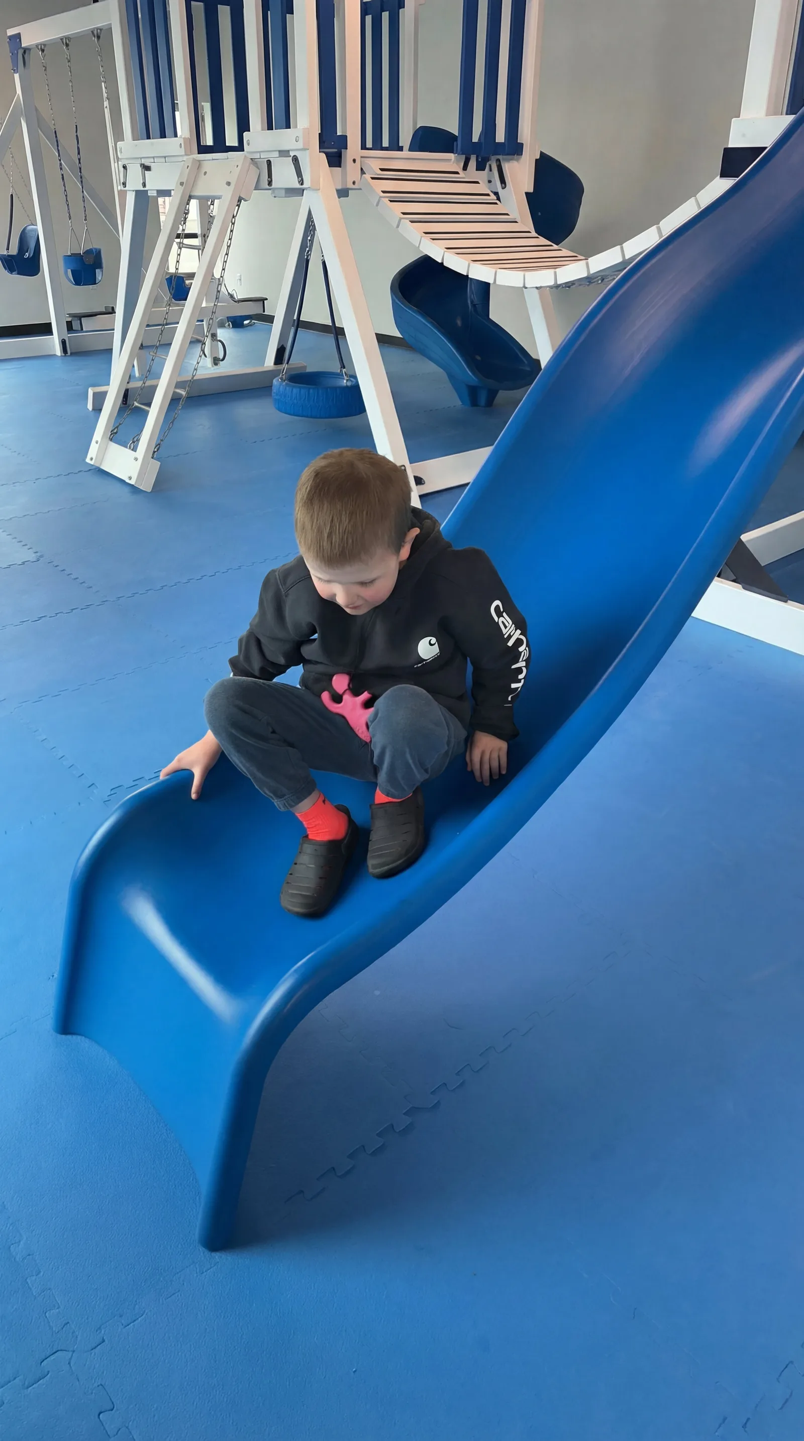 Child playing on a slide at Autism Centers of Utah